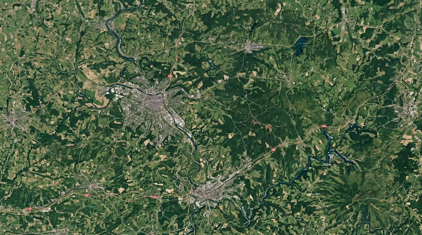 Aerial satellite view of Limousin region in central France showing Haute-Vienne, Corrèze and Creuse departments with major towns Limoges, Brive-la-Gaillarde and Guéret visible as urban centers connected by road infrastructure through predominantly rural green landscape